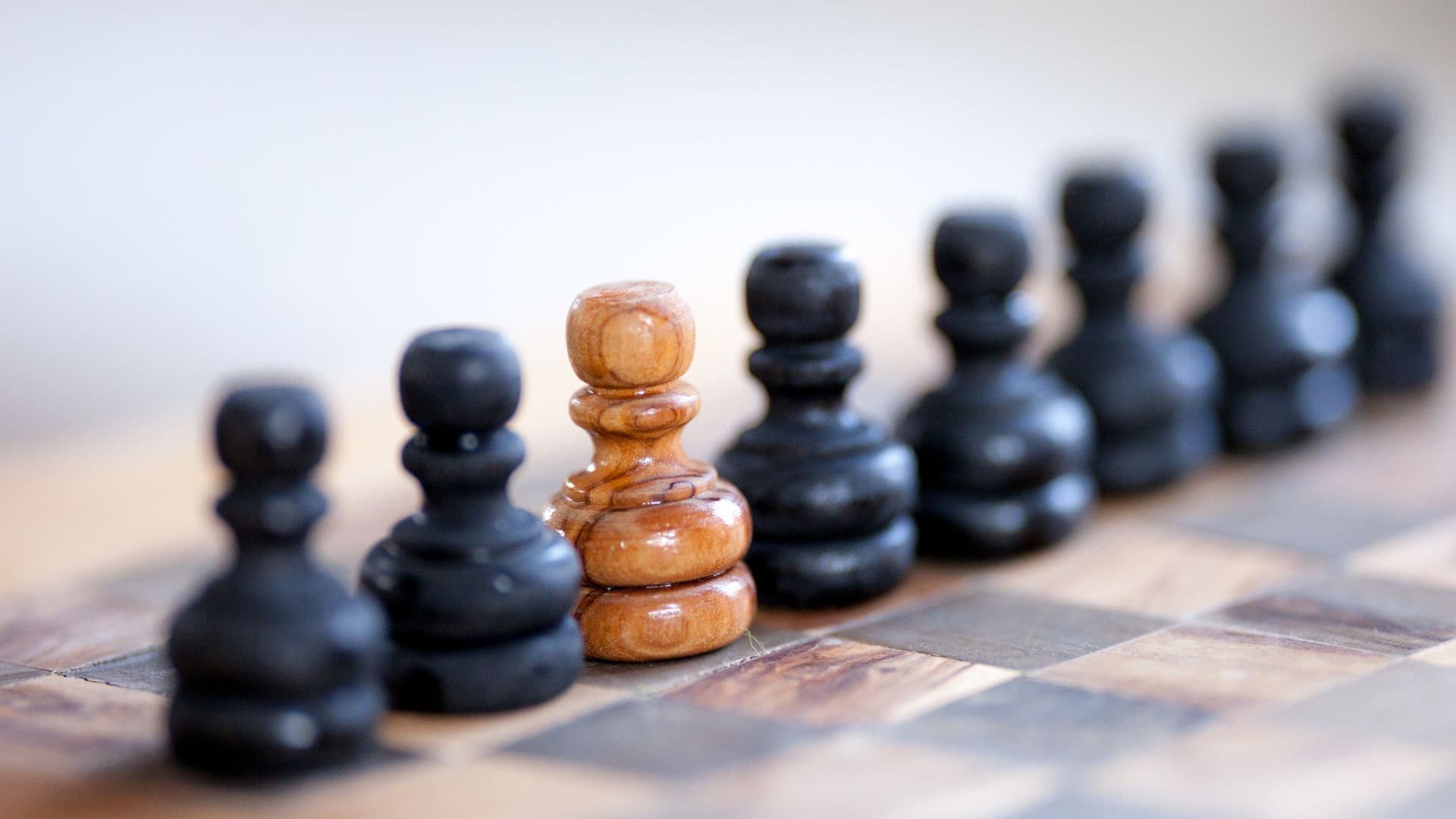 A chess board with black pieces and a single white piece, representing a unique selling point for personal injury firms